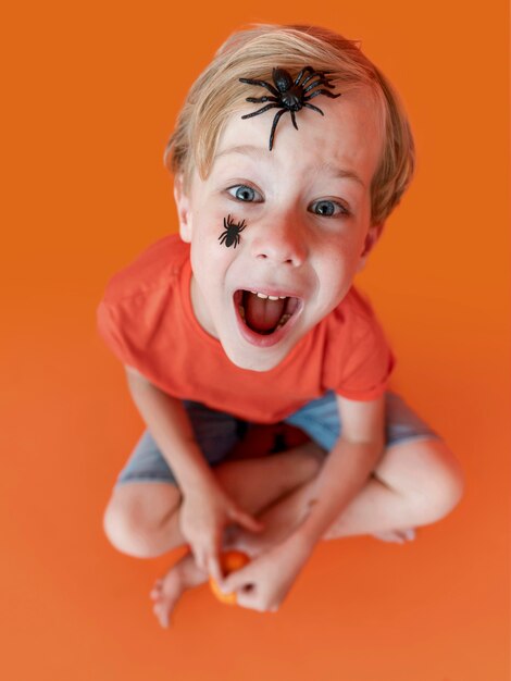 Portrait of happy kid with face painted for halloween