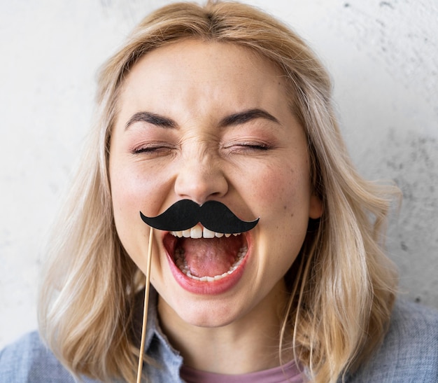 Free photo portrait of happy laughing woman with mustaches