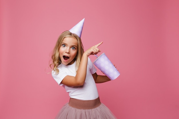 Portrait of a happy little girl in a birthday hat