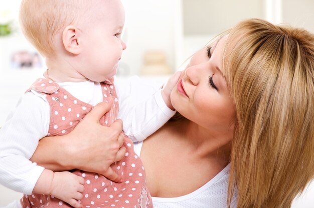 Portrait of  happy loving mother with baby at home