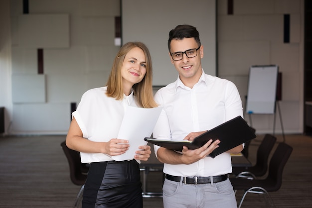 Portrait of happy male and female colleagues. 