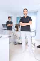 Free photo portrait of happy male and female dentist in clinic