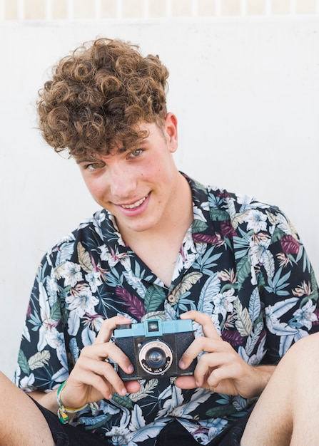 Portrait of a happy man holding camera