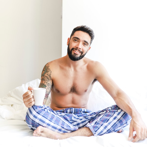 Free photo portrait of a happy man with cup of coffee