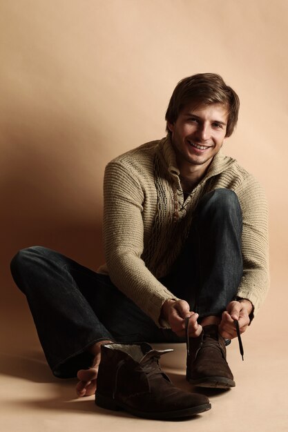 Portrait of happy man with winter shoes