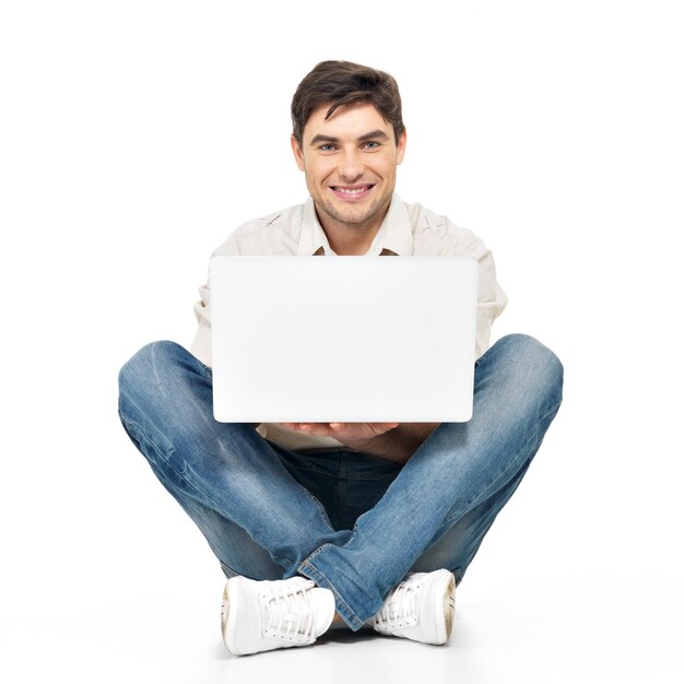 Portrait of happy man working on laptop in casuals isolated on white.