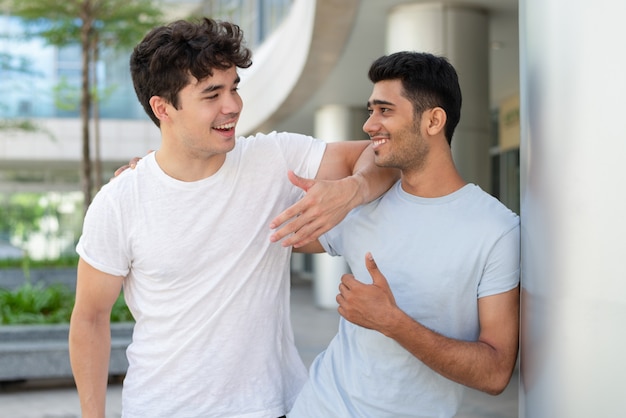 Portrait of happy multiethnic male friends talking and laughing