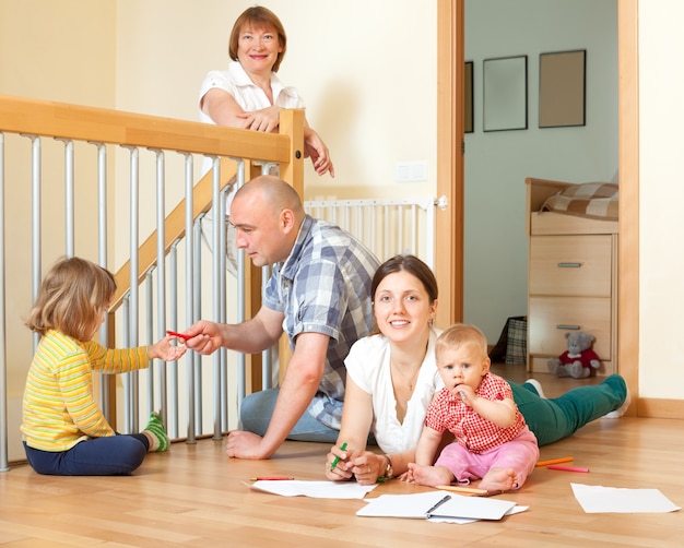 Portrait of happy multigeneration family with little children communicate