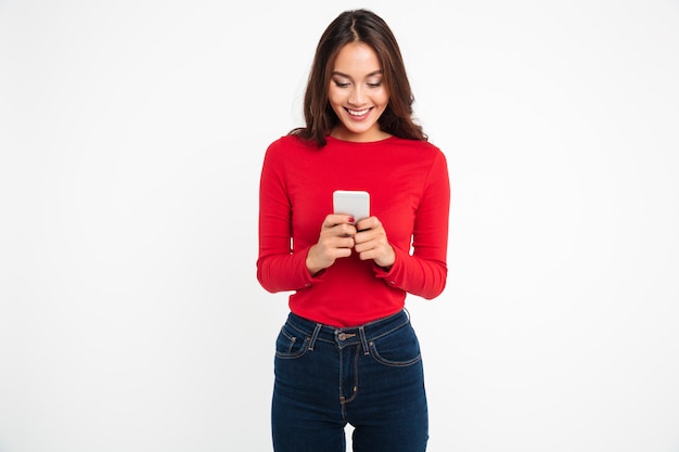 Portrait of a happy satisfied asian woman texting