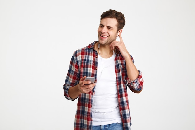 Portrait of a happy satisfied man listening to music