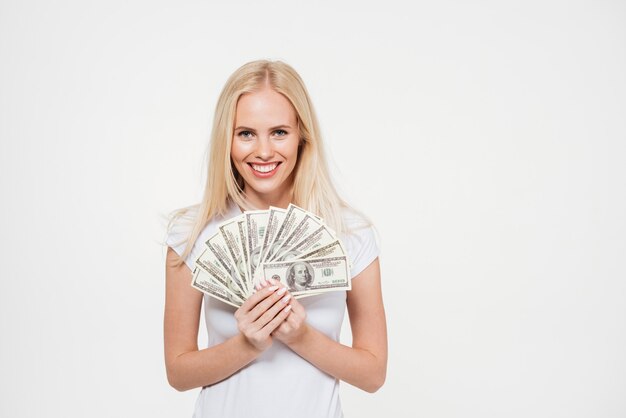 Portrait of a happy satisfied woman holding bunch of money