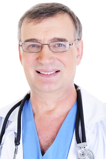 Portrait of happy senior male doctor with toothy smile and with eyeglasses