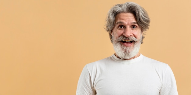 Portrait of happy senior man with copy-space