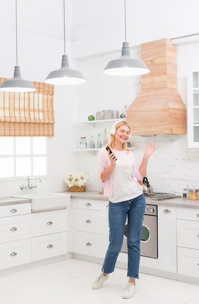 Free photo portrait of happy senior woman dancing to music