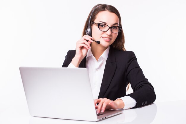 Portrait of happy smiling cheerful beautiful young support phone operator in headset with laptop, isolated over white wall