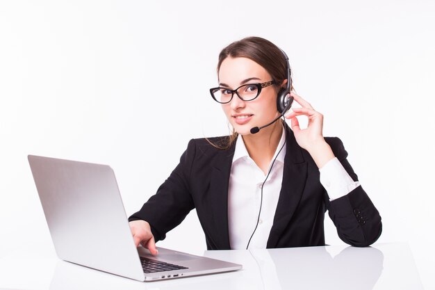 Portrait of happy smiling cheerful beautiful young support phone operator in headset with laptop, isolated over white wall