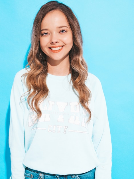 Portrait of of happy smiling girl with in casual clothes without makeup. Young woman model posing