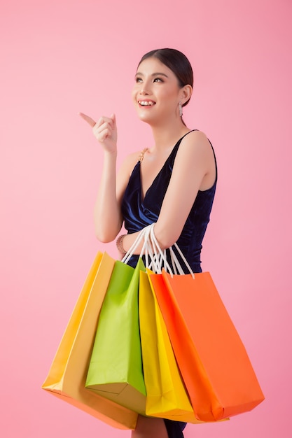 Portrait of happy smiling woman hold shopping bag