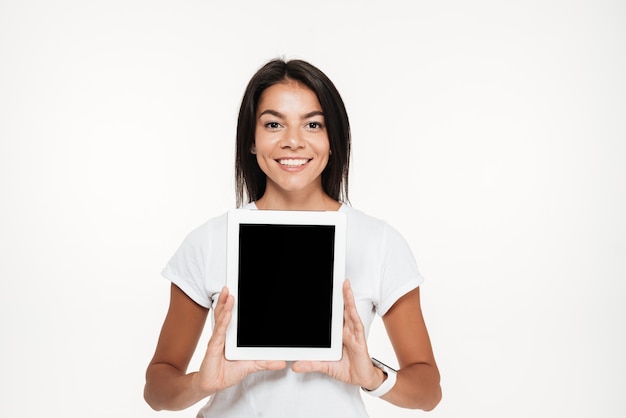 Portrait of a happy smiling woman showing blank screen tablet