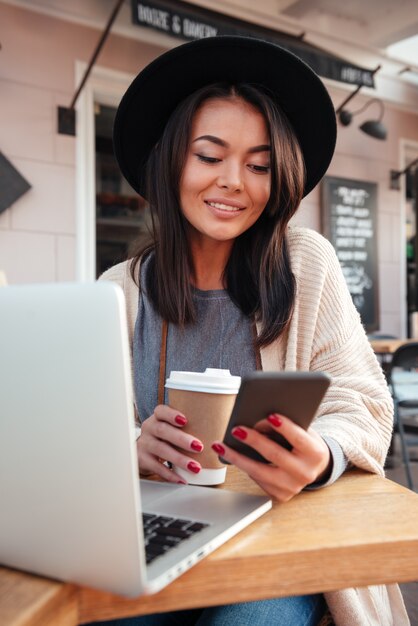 Portrait of a happy smiling woman using mobile phone