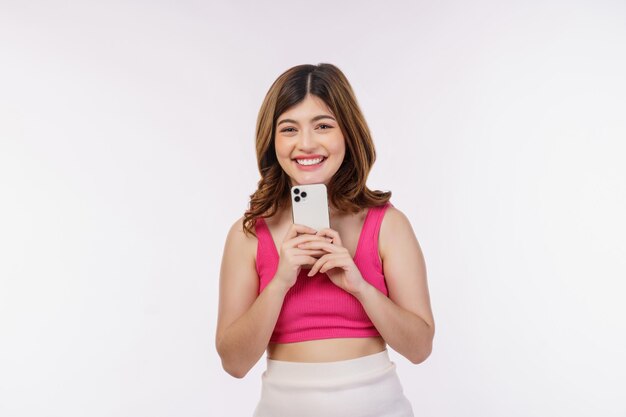 Portrait of happy smiling young woman using mobile phone isolated over white background