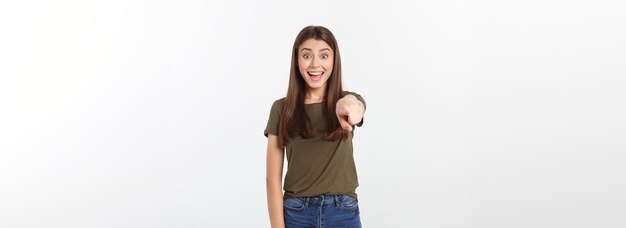 Portrait happy and surprised young lady standing isolated over grey background looking camera pointi