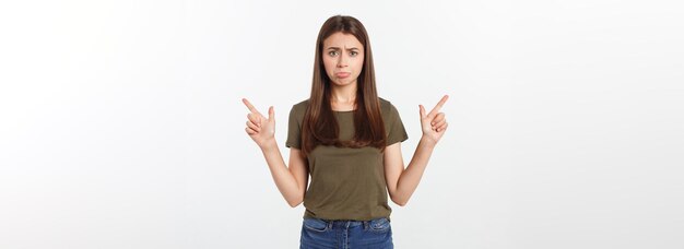 Portrait happy and surprised young lady standing isolated over grey background looking camera pointi