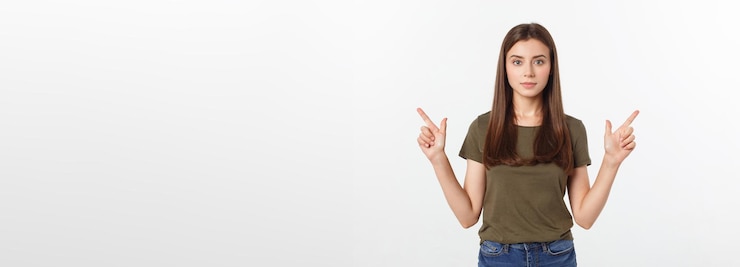 Free Photo portrait happy and surprised young lady standing isolated over grey background looking camera pointi