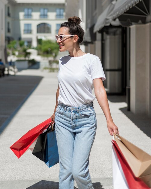 Portrait of happy woman walking with shopping bags