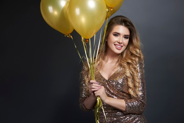 Portrait of happy woman with balloons