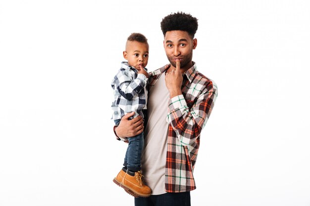 Portrait of a happy young african man holding his little son