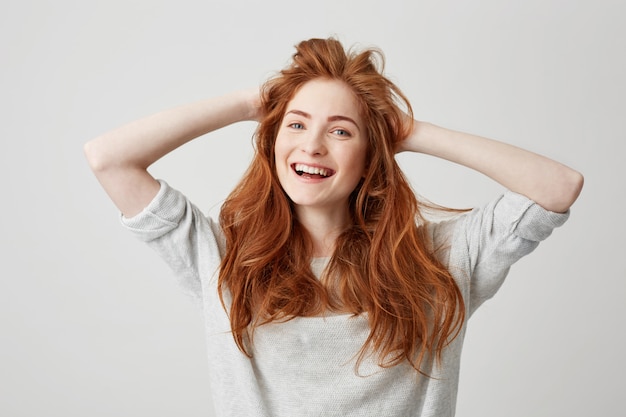 Portrait of a Smiling Redhead Girl with Beautiful Hair