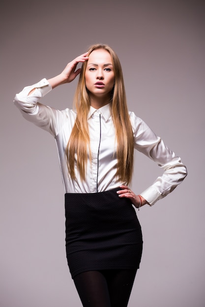 Portrait of happy young business woman isolated on white wall