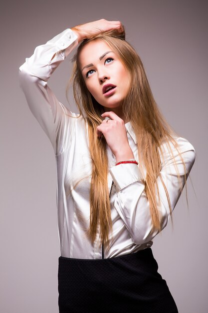 Portrait of happy young business woman isolated on white wall