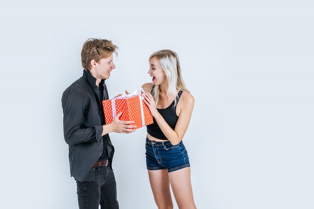 Free photo portrait of happy young couple love together surprise with gift box