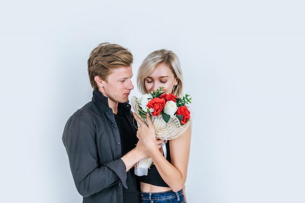 Portrait of happy young couple love together with flower 