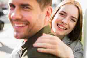 Free photo portrait of happy young loving couple on street