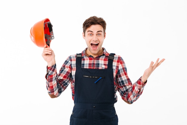 Portrait of a happy young male builder celebrating