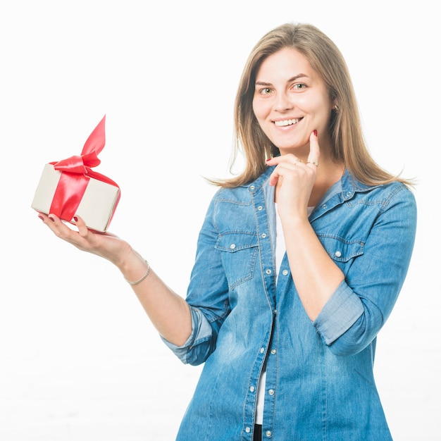 Portrait of a happy young woman holding birthday gift box