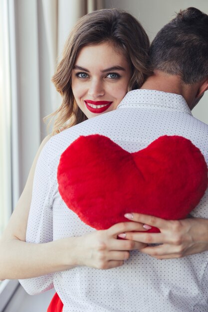 Portrait of a happy young woman holding her boyfriend