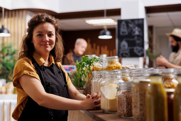 Portrait of happy zero waste shop vendor