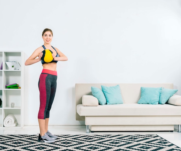 Portrait of a healthy young woman holding medical ball in hand