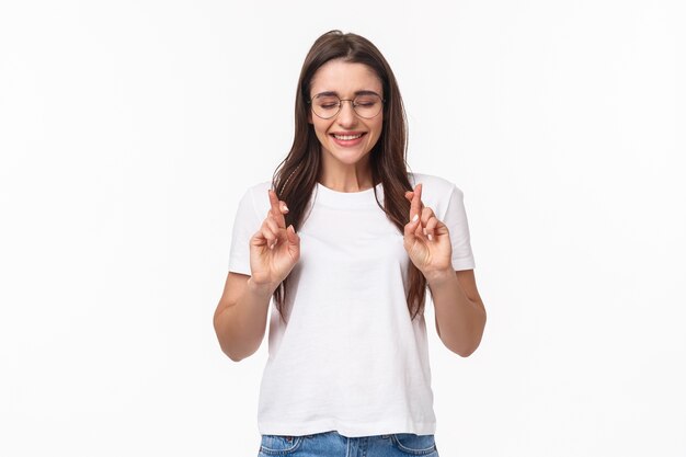portrait of hopeful, excited and optimistic young woman in glasses