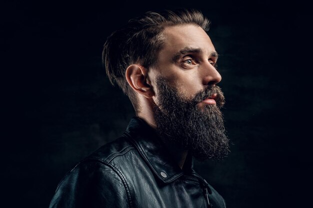 Portrait of hopeless bearded man with hairstyle on the black background.