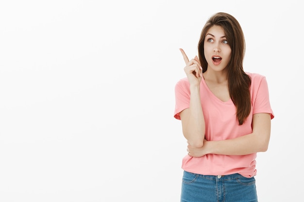 Portrait of impressed brunette woman posing in the studio