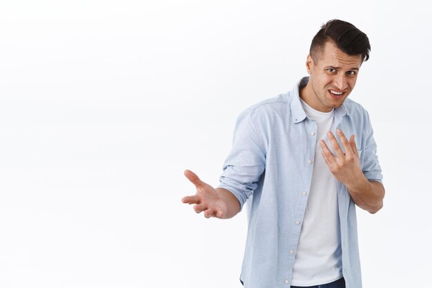 Portrait of insulted and shocked caucasian guy being accused in something pointing at himself offended and frustrated raise arm confused cant understand or believe his own ears