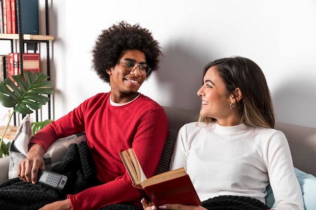 Free photo portrait of interracial couple reading together