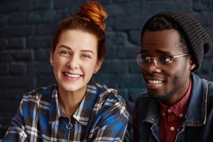 Free Photo portrait of interracial young couple of happy redhead caucasian female and stylish african male