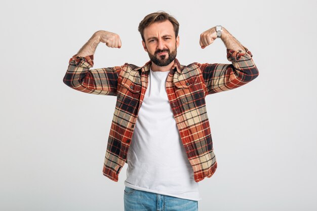 Portrait of isolated handsome brutal aggressive strong bearded man showing his muscles