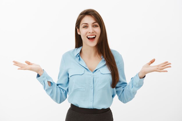 Portrait of joyful excited brunette businesswoman posing in the studio